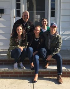 Photo of Lauren with her family outside their home